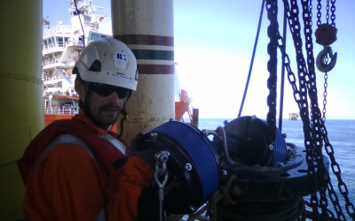 Oil worker on oil rig showing of product